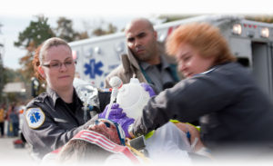 emts rushing a patient to an ambulance